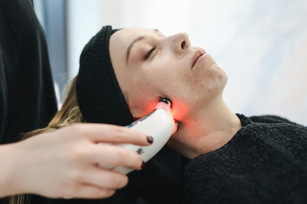 pexels-photo-3738355-3738355 An adult woman receives a laser facial treatment in a modern skincare clinic.
